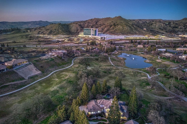 aerial view at dusk with a water and mountain view