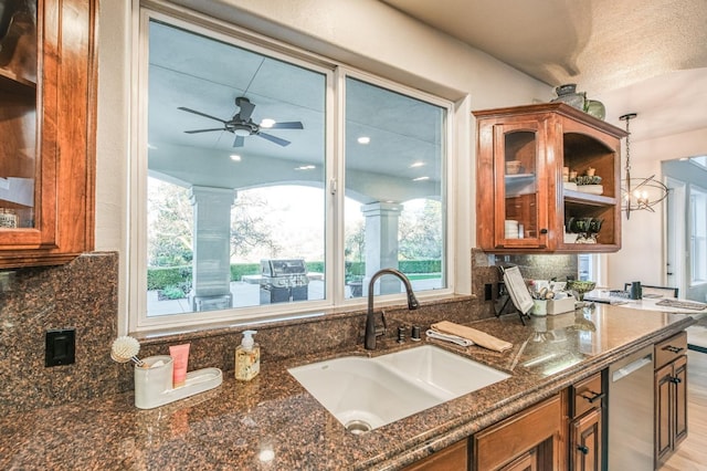 kitchen with tasteful backsplash, dishwasher, plenty of natural light, and sink