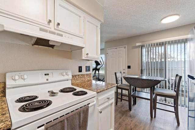 kitchen with white cabinetry, light wood-type flooring, dark stone counters, electric range, and a textured ceiling