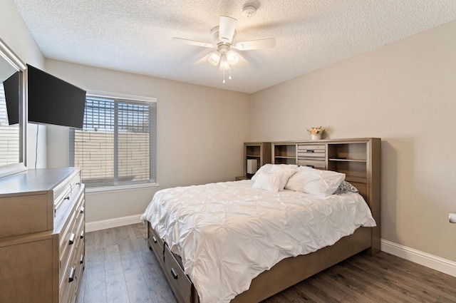 bedroom featuring ceiling fan, a textured ceiling, baseboards, and wood finished floors