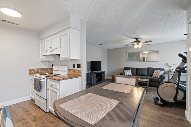 kitchen with white electric range, ceiling fan, dark stone countertops, dark hardwood / wood-style floors, and white cabinets