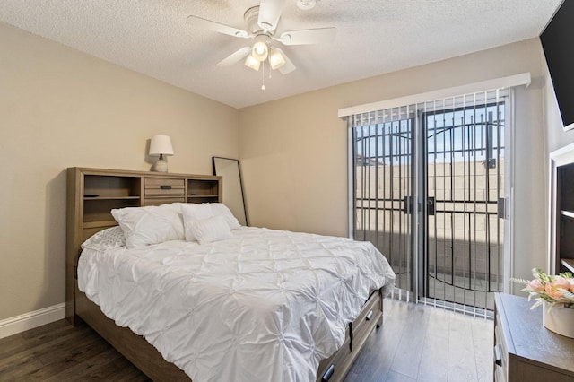 bedroom featuring dark hardwood / wood-style flooring, a textured ceiling, and ceiling fan