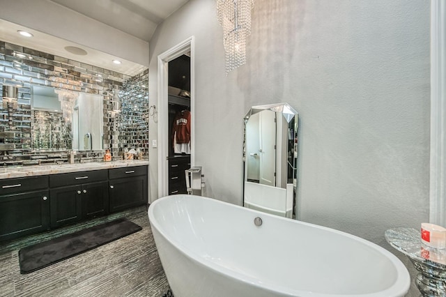 bathroom with vanity and a bath