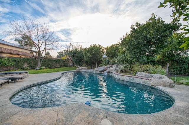 view of pool featuring pool water feature and a jacuzzi