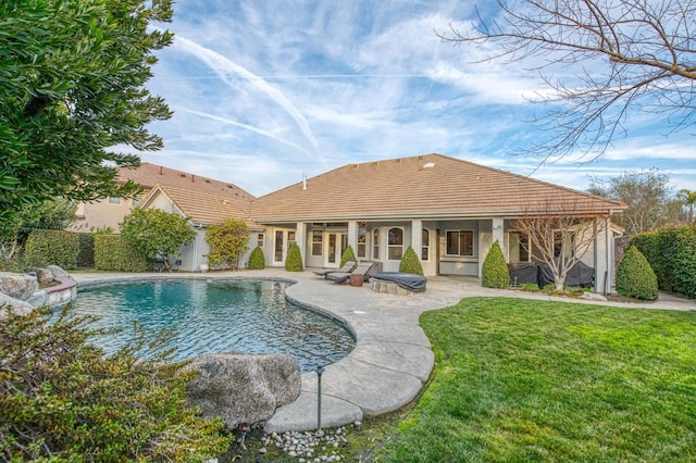 view of pool with a yard, a patio, and french doors