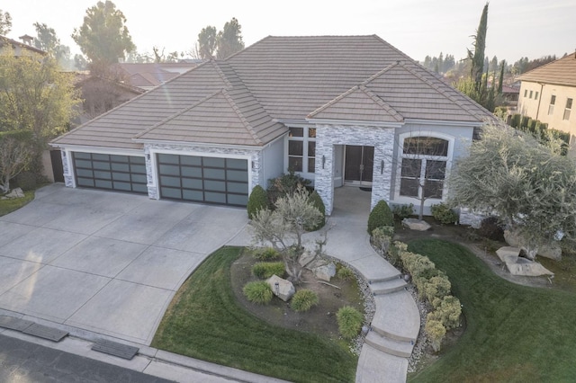 view of front of property with a garage and a front lawn