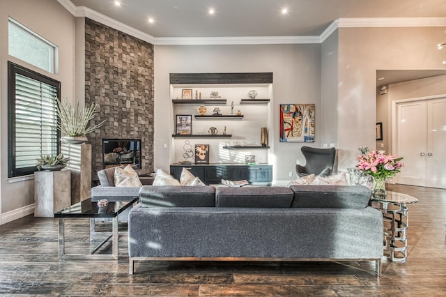 living room featuring hardwood / wood-style flooring, a fireplace, and ornamental molding