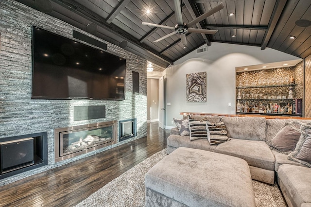 living room with lofted ceiling with beams, wooden ceiling, hardwood / wood-style flooring, ceiling fan, and a fireplace