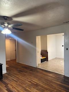 unfurnished room with dark wood-type flooring and ceiling fan