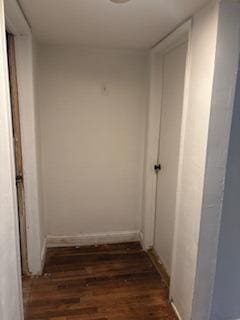 corridor featuring dark hardwood / wood-style floors