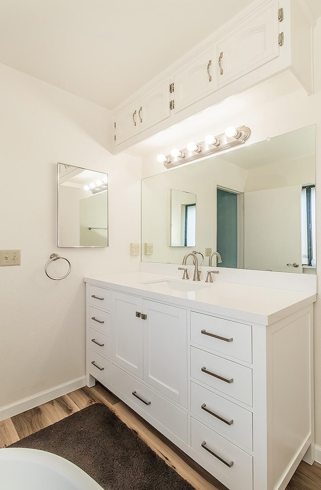 bathroom featuring vanity and hardwood / wood-style floors