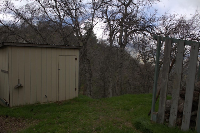 view of outdoor structure featuring a lawn