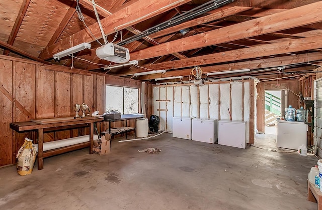 interior space with a garage door opener and refrigerator