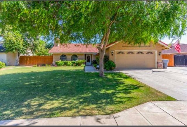 single story home with a garage and a front lawn