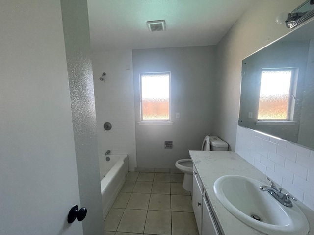 bathroom featuring tasteful backsplash, tile patterned floors, toilet, and vanity