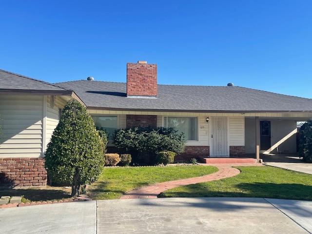 129 N Armstrong Ave, Fowler, CA 93625 - single story home featuring brick siding, a chimney, a front lawn, and covered porch