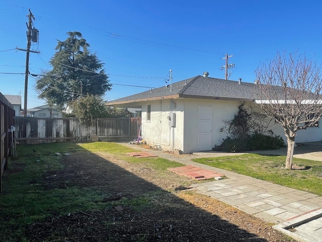 view of side of property with a lawn