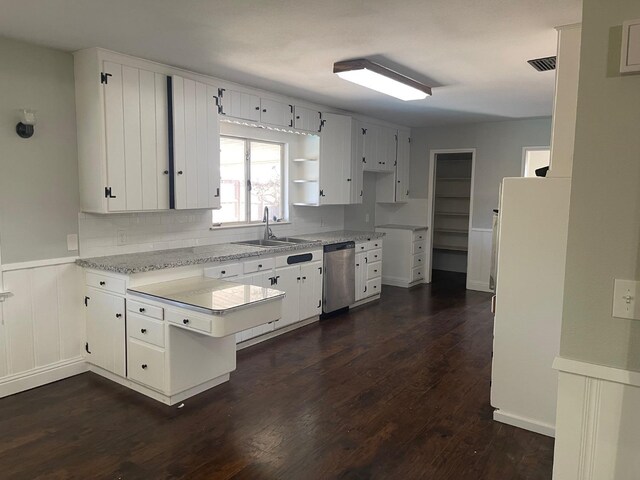 129 N Armstrong Ave, Fowler, CA 93625 - kitchen featuring dishwasher, a wainscoted wall, a peninsula, a sink, and dark wood-style flooring
