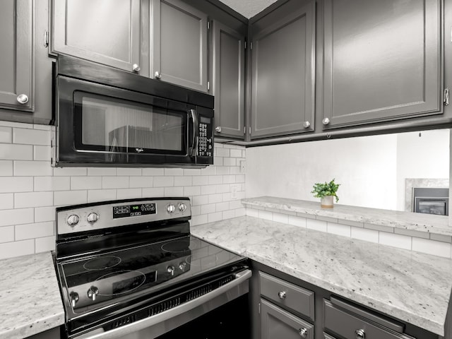 kitchen featuring tasteful backsplash, gray cabinetry, and electric stove