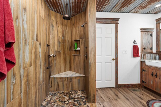 bathroom with vanity, wood-type flooring, and a shower