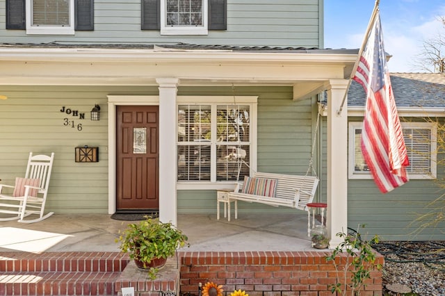 view of exterior entry featuring a porch