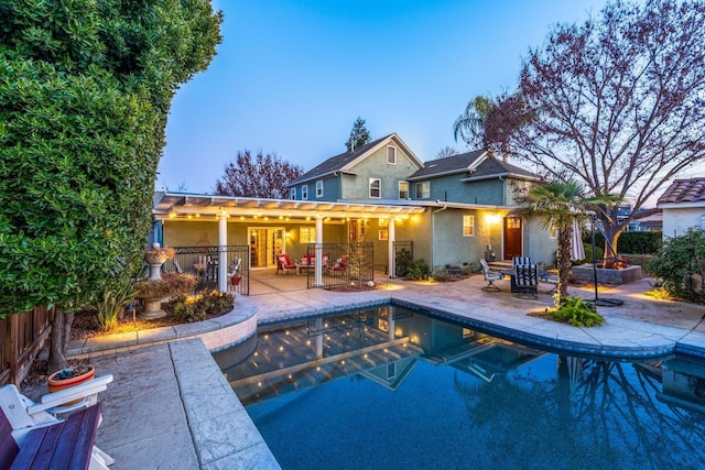 pool at dusk with a patio