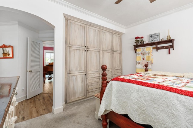 carpeted bedroom with crown molding and ceiling fan