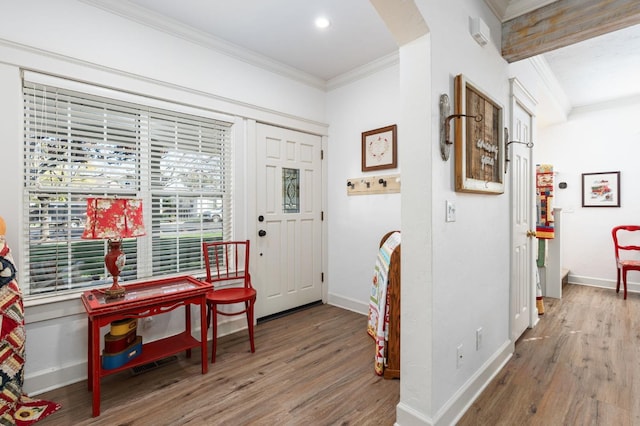 foyer entrance featuring hardwood / wood-style flooring and crown molding