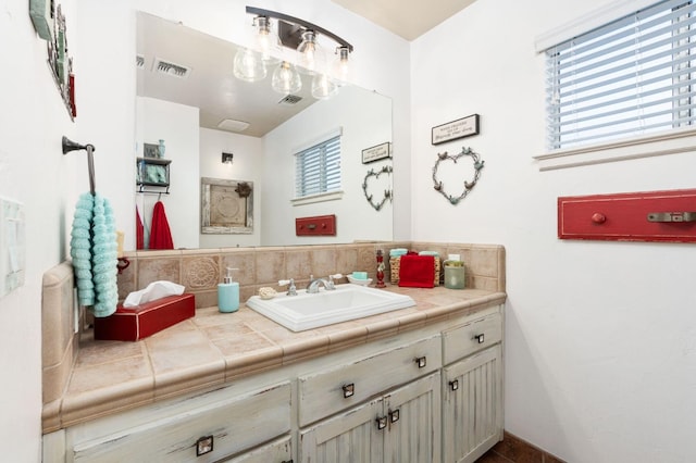 bathroom with vanity and decorative backsplash