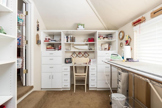 office area with vaulted ceiling and dark colored carpet