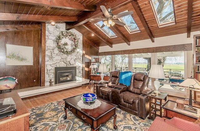 3670 S Newmark Ave, Sanger, CA 93654 - living room with wood ceiling, a ceiling fan, a skylight, wood finished floors, and a fireplace