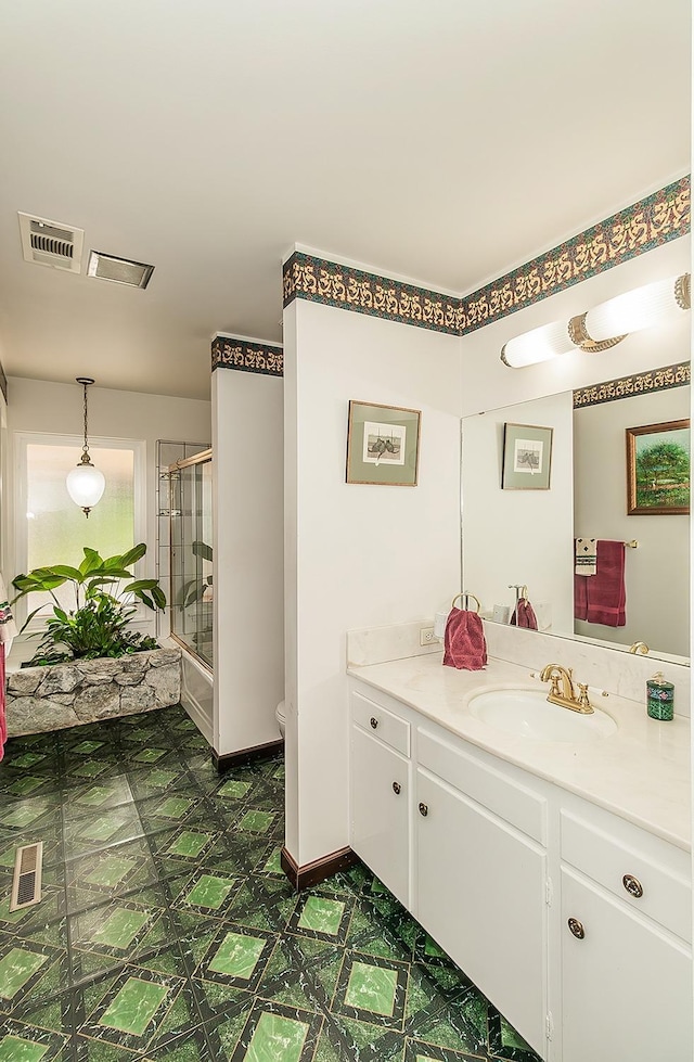 3670 S Newmark Ave, Sanger, CA 93654 - bathroom featuring vanity, an enclosed shower, tile patterned floors, and toilet