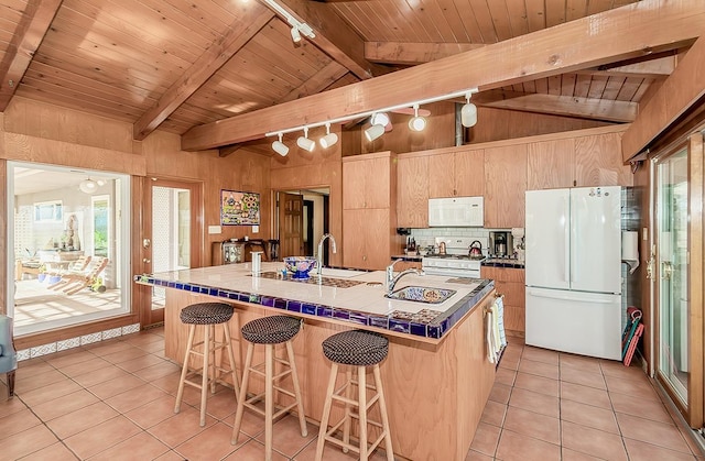 3670 S Newmark Ave, Sanger, CA 93654 - kitchen with white appliances, rail lighting, light tile patterned flooring, a sink, and wooden ceiling