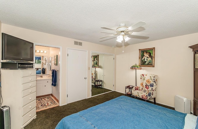3670 S Newmark Ave, Sanger, CA 93654 - carpeted bedroom featuring ensuite bathroom, a ceiling fan, a textured ceiling, and a closet