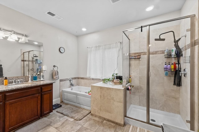 bathroom featuring vanity, shower with separate bathtub, and tile patterned floors