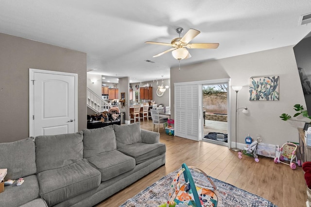 living room with hardwood / wood-style flooring and ceiling fan