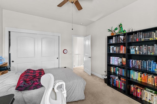 carpeted bedroom featuring ceiling fan and a closet