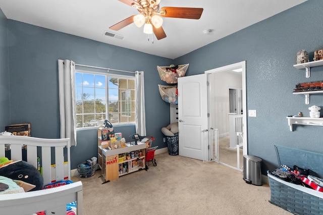 bedroom with light carpet and ceiling fan