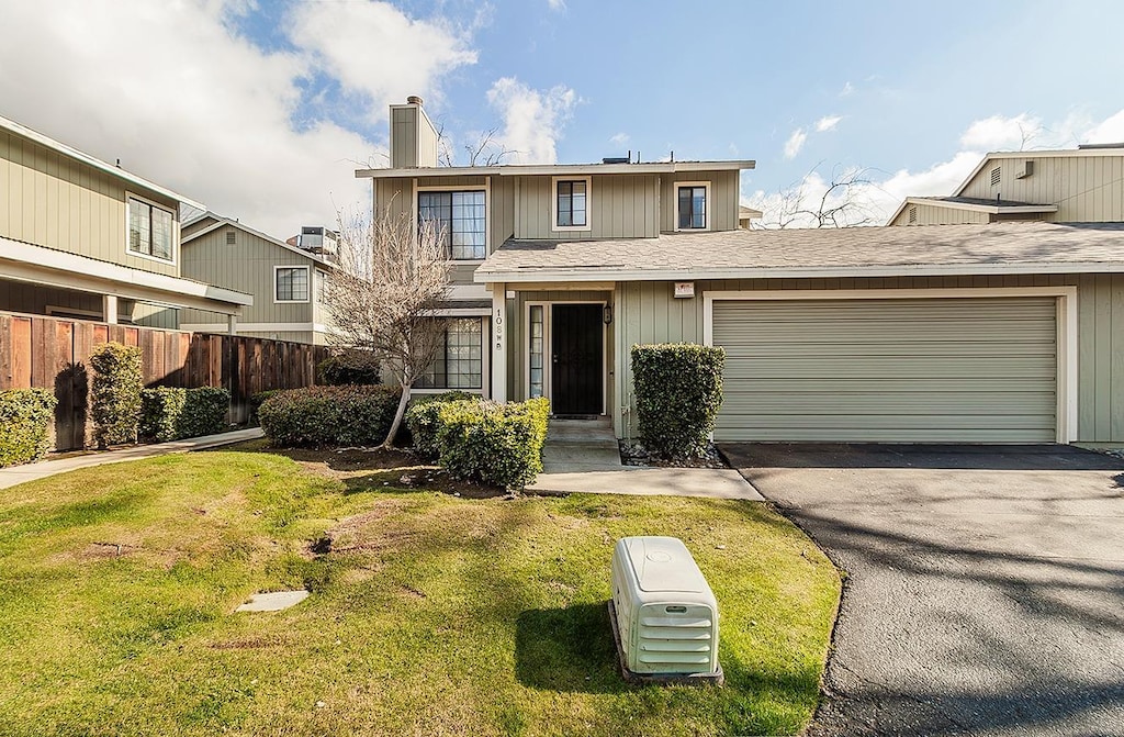 front facade with a garage, central AC, and a front lawn