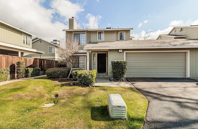 front facade with a garage, central AC, and a front lawn