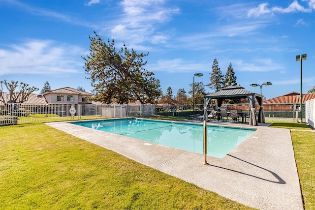 view of swimming pool with a yard and a gazebo