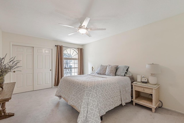 carpeted bedroom with a closet and ceiling fan