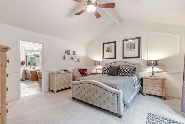 carpeted bedroom featuring ceiling fan, ensuite bathroom, sink, and lofted ceiling with beams