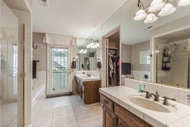 bathroom with vanity, tile patterned flooring, and shower with separate bathtub