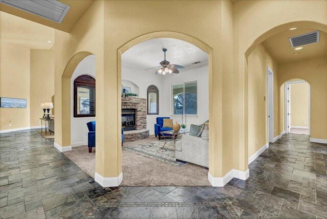 view of patio / terrace featuring a fireplace and ceiling fan