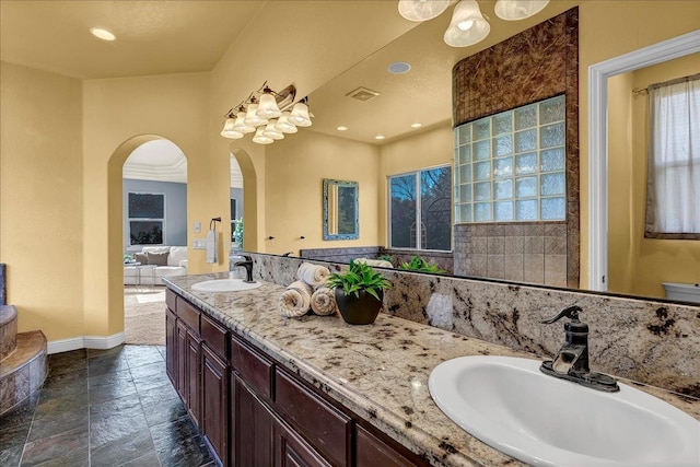 bathroom featuring vanity, a bath, and a healthy amount of sunlight