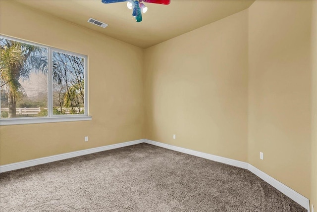 empty room with a wealth of natural light, carpet floors, and ceiling fan