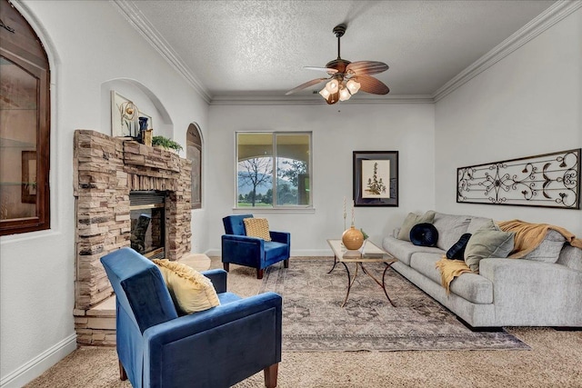 living room featuring ornamental molding, a stone fireplace, carpet floors, and a textured ceiling