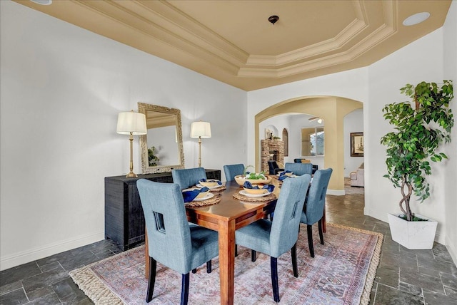 dining room featuring ornamental molding and a raised ceiling