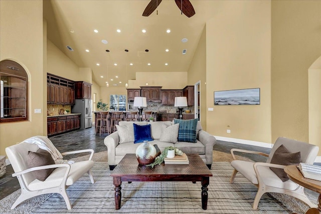 living room featuring a high ceiling and ceiling fan